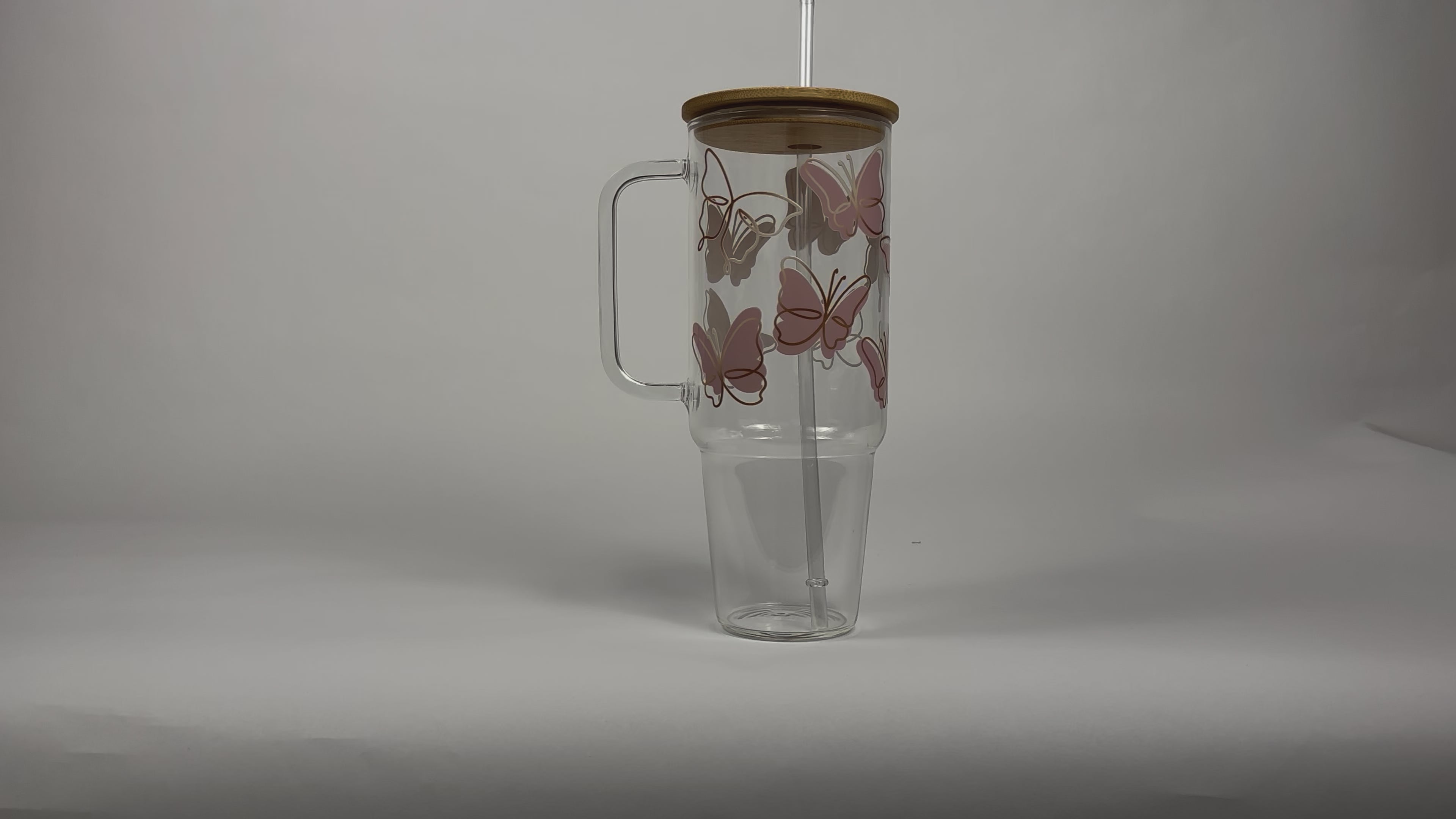 Load video: Pink Butterflies 40oz Glass Tumbler With Lid and Straw